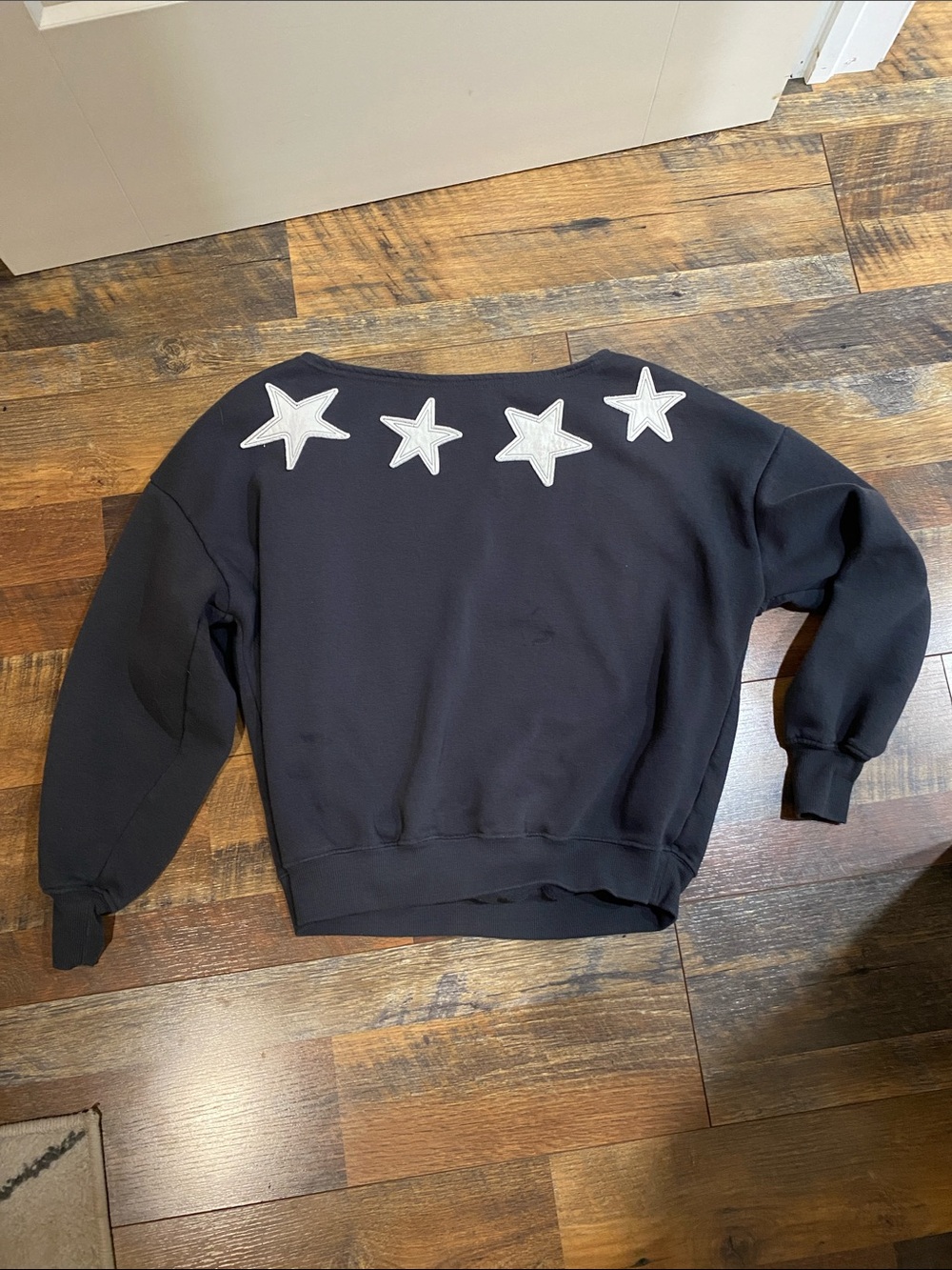Off the shoulder black long sleeve top with white stars